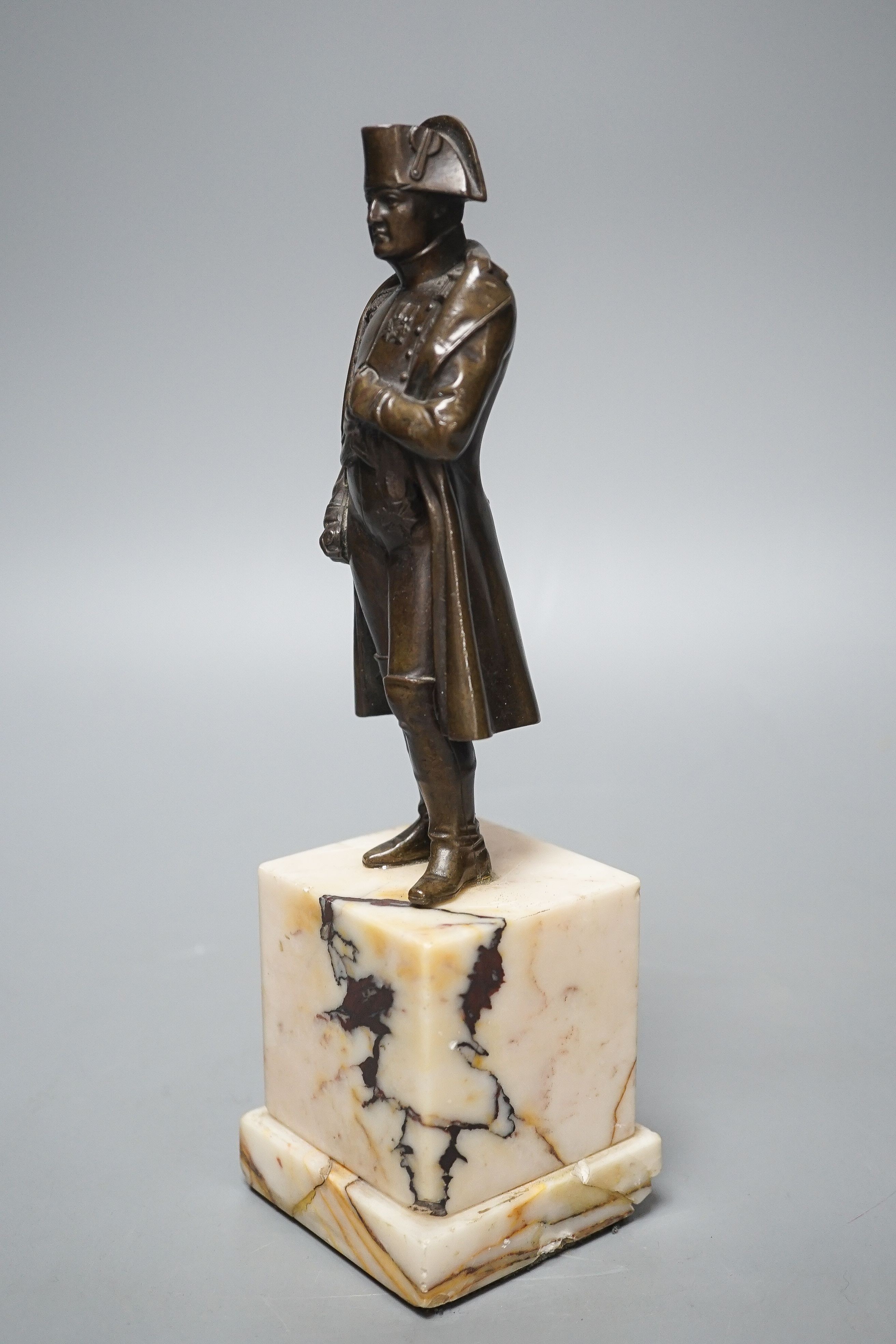 A bronze figure of Napoleon on marble base and two related prints ‘Porto Ferrajo’ and ‘Grand Entry of the Allied Sovereigns into Paris’ bronze 24cm tall